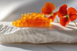 Golden Osetra caviar perched on porcelain slab with vibrant nasturtium petals and verbena foam detailing photo