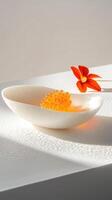 Golden Osetra caviar on porcelain slab with verbena foam and nasturtium petals photo