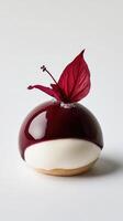 Minimalist profiterole with vanilla cream and tropical guava ganache topped with crystallized hibiscus petal for dessert lovers photo