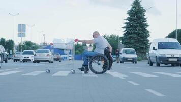Man with disabilities in wheelchair pushing cart in front of himself at supermarket parking 7 video