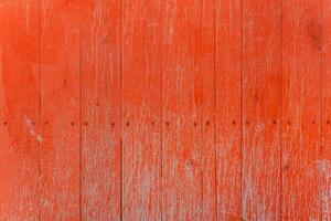 A fence of dirty red boards covered with stains and smudges. Natural decorative background. photo
