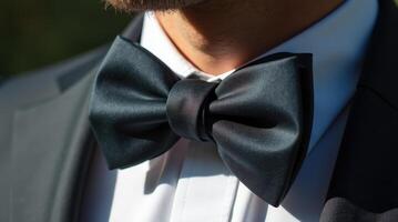Close-up view of a man's neck showcasing an intricately crafted bowtie photo