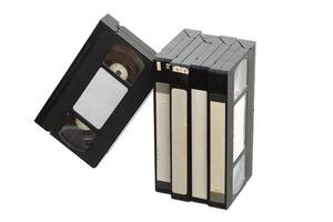 Group of vintage VHS tapes with blank labels, standing and leaning on white back photo