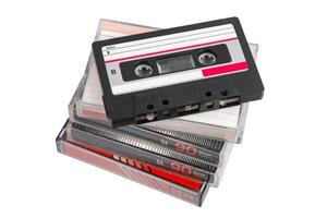 Stack of retro audio cassettes with one on top, angled and uncovered, on white back photo