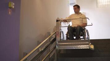 Special elevator for the person with a physical disabilities. A man in a wheelchair uses a special elevator 16 video