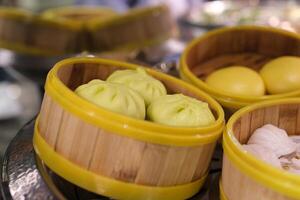 Various of dim sum on wooden steamer close-up macro. Steaming Technique. Chinese dessert food. Dimsum with shrimps, fish and meat. Dish in a cafe. Homade. Delivery photo