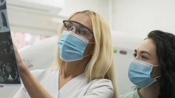 Radiologists Reviewing Scans on Digital Tablet in Hospital Setting video