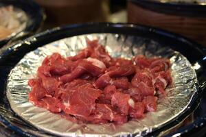 Sliced raw meat Raw pieces of beef top view, rotation. Prepare beef for cooking photo