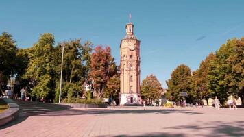 Timelapse of people walking in a beautiful park with many trees and a clock tower video