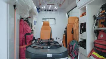 Inside the ambulance, view from the sanitary compartment. Different medical equipment and a stretcher. video