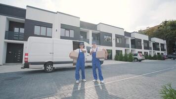 Two young workers of removal company deliver boxes to a customer's home 2 video