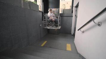 Special elevator for the person with a physical disabilities. A man in a wheelchair uses a special elevator 14 video