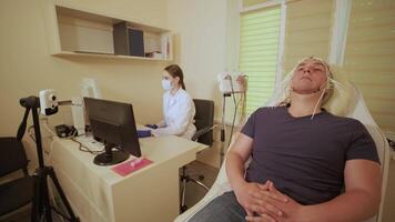 Patient brain testing using encephalography at medical center video