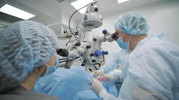 Surgeons Operating with Microscope in Sterile Surgical Suite video