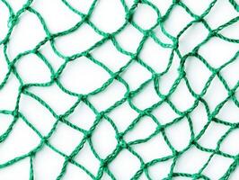 Green fishing net with intricate knot patterns on white background photo