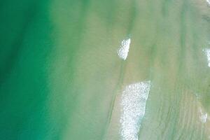 drone photography of turquoise water and wave foam, aerial top down drone photography. Summer background concept photo