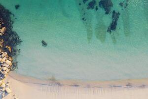 turquoise and transparent water of the sea on the shore of a beach in Rias Baixas, Galicia. Spain, Aerial drone top view photo
