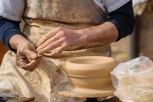 close up of ceramic artist working with natural clay, creative process of handmade pottery art background photo