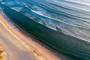 mediterranean or atlantic coastline, drone top down view of nature at sunset photo