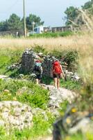 selective focus of two pilgrims making the Way of St. James along the coast from Portugal photo