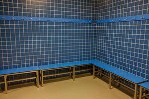 clean and organized pool changing room with seating photo