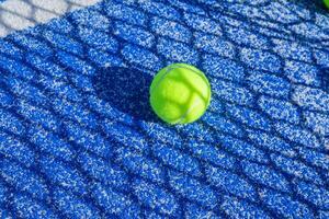 padel court showcasing the unique texture of the blue playing surface and bright balls photo