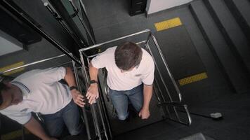 Special elevator for the person with a physical disabilities. A man in a wheelchair uses a special elevator 8 video