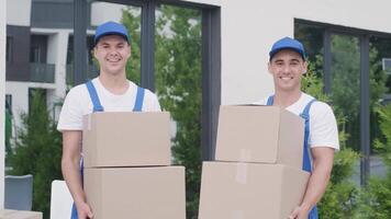 Two young workers of removal company deliver boxes to a customer's home 8 video