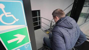 Special elevator for the person with a physical disabilities. A man in a wheelchair uses a special elevator 2 video