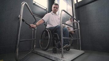 Special elevator for the person with a physical disabilities. A man in a wheelchair uses a special elevator 12 video