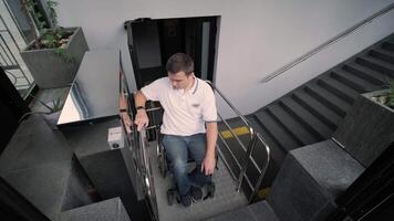 Special elevator for the person with a physical disabilities. A man in a wheelchair uses a special elevator 3 video