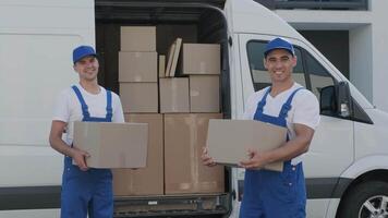Two young workers of removal company unload boxes from minibus into customer's home 5 video