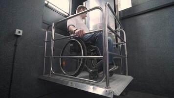 Special elevator for the person with a physical disabilities. A man in a wheelchair uses a special elevator 10 video