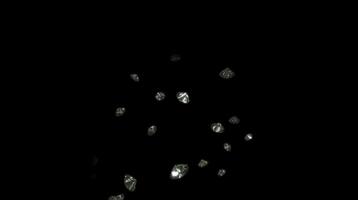 A bunch of diamonds are falling down in the dark video