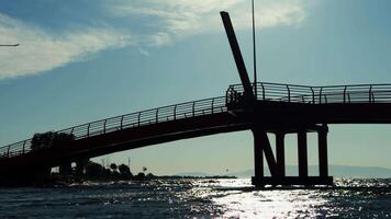 Cyclist Crossing a Bridge Over the Sea at Sunset in Turkey video