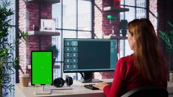 Mature adult utilizes digital AI tool on web interface next to green screen, remote work. Artificial intelligence powered interface simplifies communication and increases efficiency. Camera A. video