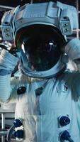 Vertical Space helmet next to laptop in spaceship showing mission logs during orbital flight. Astronaut equipment prepared for planetary expedition and notebook displaying star charts video