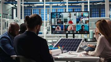 Photovoltaics researchers doing internet videocall, working on breakthroughs in durability. Factory development team in remote teleconference testing materials for solar panels video