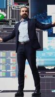 Vertical Public speaker CEO hosting business presentation to share a vision, discuss about new growth strategy and ideas for global development. Using a hands free microphone for attendees. Camera B. video