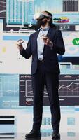 Vertical Administrator uses VR glasses to analyze digital graphs and business insight, improving new strategy models for successful development decisions. Optimizing performance with fintech. Camera B. video