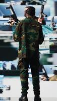 Vertical Armed forces soldier gathers surveillance from digital drone systems, preparing for combat with warfare strategies and battlefield details. War planning operations in command center. Camera B. video