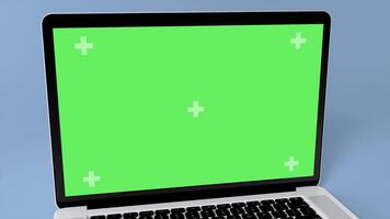 Green Screen Display Laptop Opens and Rotate on a Blue Background. Empty Green Mock-up Monitor for Call, Website Template Presentation or Game Applications. Blank Screen Monitor 3D render video