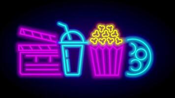 A comprehensive neon display featuring a clapboard, drink, and popcorn bucket, lit with pink, blue, and yellow to capture moviegoing excitement video
