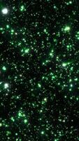 Green glowing bokeh particles scattered on a dark background, forming a radiant visual explosion of light points video