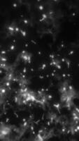 Vivid explosion of glowing particles around a black central void in radial formation video