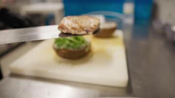 Chef Adding Grilled Swordfish On Top Of The Vegetables Preparing A Burger video