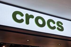 Bangkok, Thailand May 17, 2025 Crocs sign. It is an American footwear company based in Broomfield, Colorado that was founded in 2002. photo
