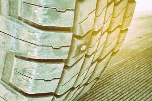 Close up Nails Embedded in Car Wheel. photo
