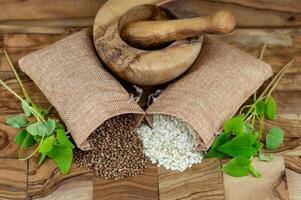 buckwheat Fagopyrum esculentum mortar and 2 jute sack photo