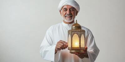Arab old man holding a lantern. photo